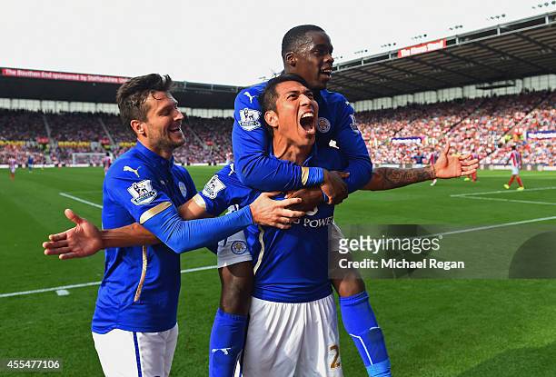 Leonardo Ulloa of Leicester City celebrates scoring the first goal with David Nugent and Jeffrey Schlupp of Leicester City during the Barclays...