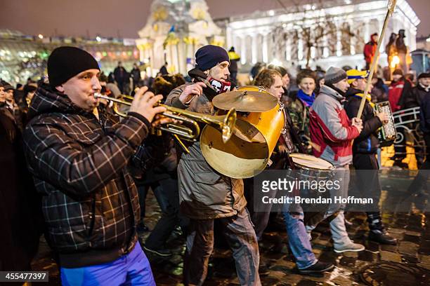 Small band performs while walking around Independence Square during ongoing anti-government protests on December 12, 2013 in Kiev, Ukraine. Thousands...
