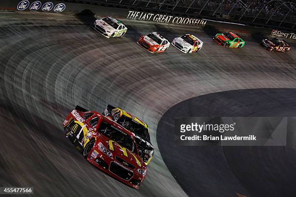 Jamie McMurray, driver of the McDonald's Chevrolet, races with Michael Annett, driver of the Pilot Flying J Chevrolet, during the NASCAR Sprint Cup...