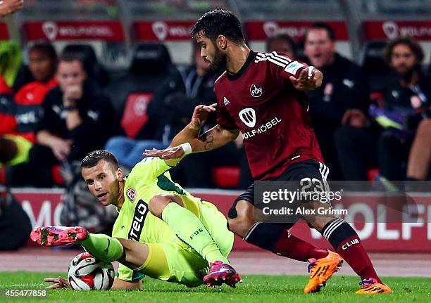 Lukas Schmitz of Duesseldorf is challenged by Daniel Candeias of Nuernberg during the Second Bundesliga match between 1. FC Nuernberg and Fortuna...