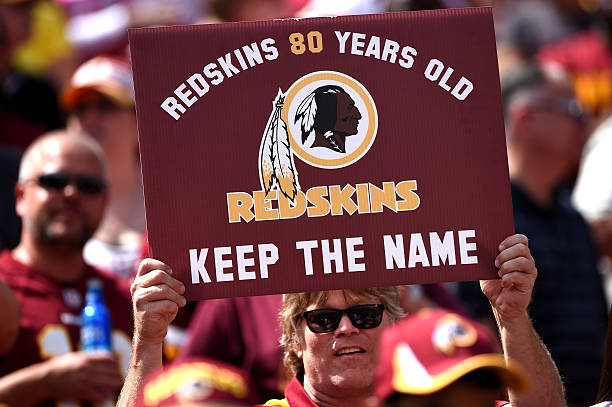 Washington Redskins fan holds up a sign to keep the Redskins name before they play the Jacksonville Jaguars at FedExField on September 14, 2014 in...