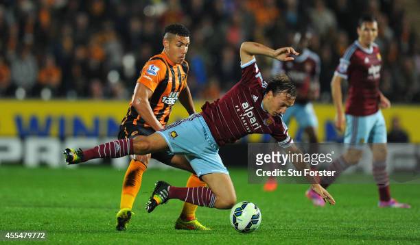 Hull player Jake Livermore challenges Mark Noble of West Ham during the Barclays Premier League match between Hull City and West Ham United at KC...