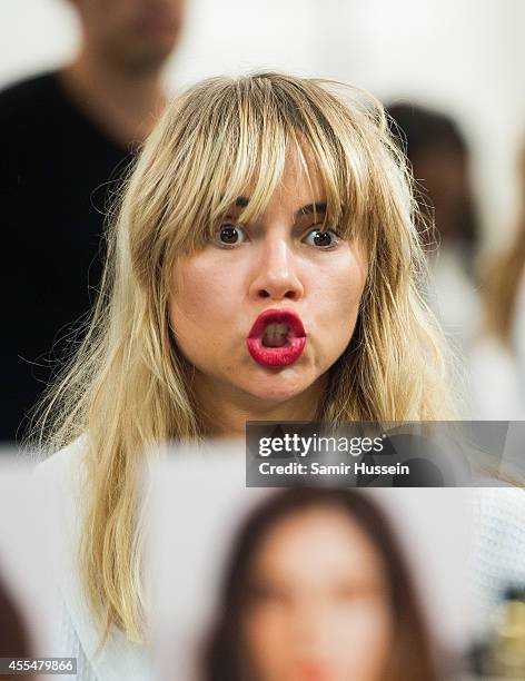 Suki Waterhouse prepares backstage at the Burberry Prorsum show during London Fashion Week Spring Summer 2015 at on September 15, 2014 in London,...