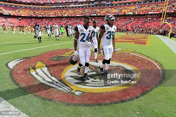 Will Blackmon and Demetrius McCray of the Jacksonville Jaguars walk off the fiedl following the Jaguars 41-10 loss to the Washington Redskins during...