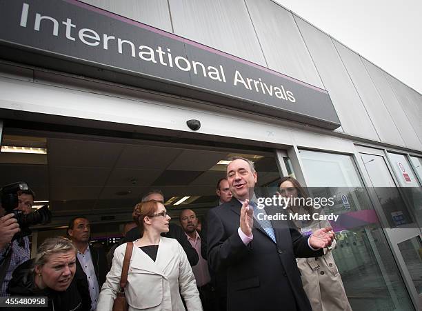 First Minister Alex Salmond gestures as he leaves Edinburgh International Airport following a photocall in the arrival's hall on September 15, 2014...