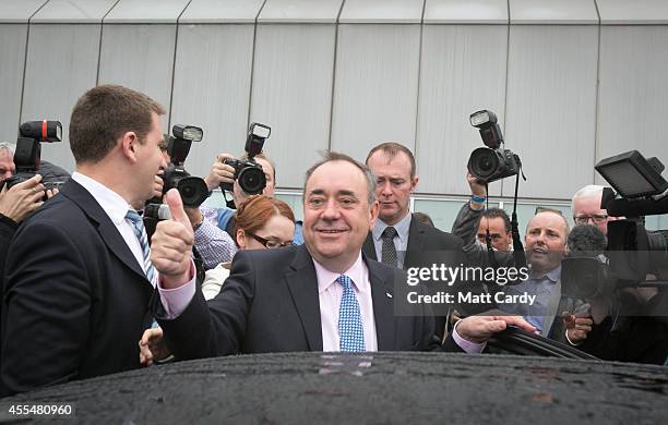 First Minister Alex Salmond gestures as he leaves Edinburgh International Airport following a photocall in the arrival's hall on September 15, 2014...