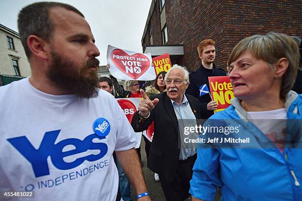 Yes and No supporters exchange words during, as Alistair Darling leader of the Better Together meets with members of the public during a walk about...