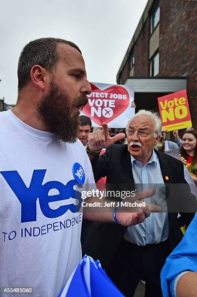 Yes and No supporters exchange words during, as Alistair Darling leader of the Better Together meets with members of the public during a walk about...