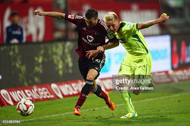 Ondrej Celustka of Nuernberg is challenged by Axel Bellinghausen of Duesseldorf during the Second Bundesliga match between 1. FC Nuernberg and...