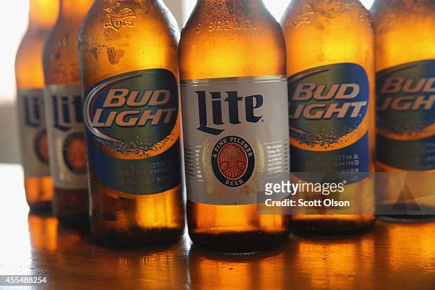 In this photo illustration, bottles of Miller Lite and Bud Light beer that are products of SABMiller and Anheuser-Busch InBev are shown on September...