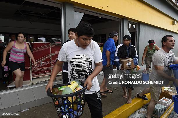 People loot a supermarket in Cabo San Lucas on September 15, 2014 after hurricane Odile knocked down trees and power lines in Mexico's Baja...