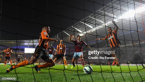 Hull defenders look on as West Ham defender James Tomkins celebrates the second West Ham goal during the Barclays Premier League match between Hull...