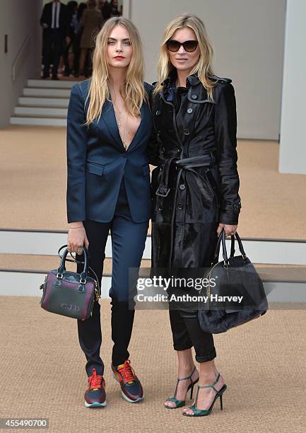 Cara Delevingne and Kate Moss attend the Burberry Prorsum show Womens wear 2015 during the London Fashion Weekk SS15 on September 15, 2014 in London,...