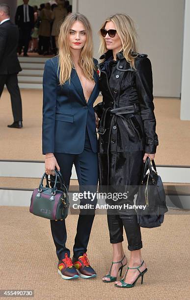 Cara Delevingne and Kate Moss attend the Burberry Prorsum show Womens wear 2015 during the London Fashion Weekk SS15 on September 15, 2014 in London,...