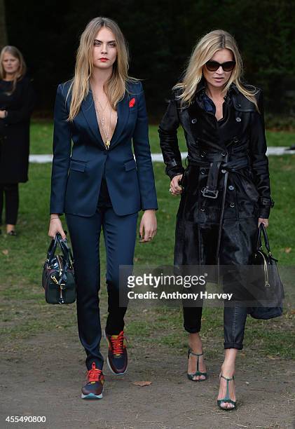 Cara Delevingne and Kate Moss attend the Burberry Prorsum show Womens wear 2015 during the London Fashion Weekk SS15 on September 15, 2014 in London,...