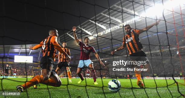 Hull defender Curtis Davies ldiverts the ball into his own net as West Ham defender James Tomkins celebrates the second West Ham goal during the...