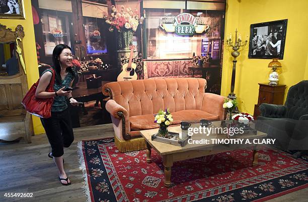 Woman walks inside a temporary "pop up" reproduction of the "Central Perk" coffee shop, a center piece set of the television situation comedy...