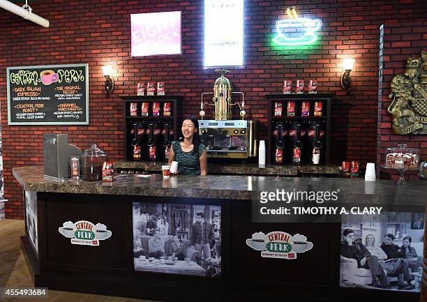 A woman works behind the counter inside a temporary "pop up" reproduction of the "Central Perk" coffee shop, a center piece set of the television...