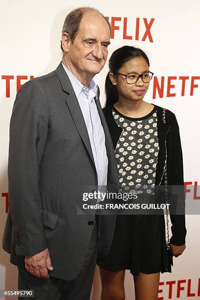 French journalist and television executive Pierre Lescure and his daughter Anna pose during a photocall for the launch of Netflix in France on...