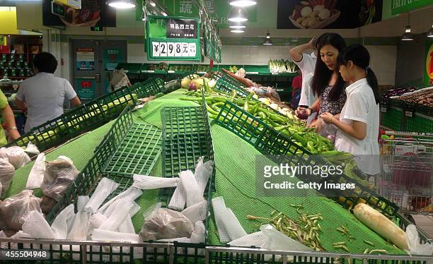 Goods shelves of a supermarket are almost empty after a shopping rush during the upcoming typhoon Kalmaegi on September 15, 2014 in Haikou, Hainan...