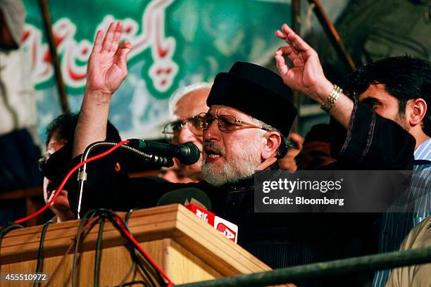 Islamic cleric Muhammad Tahir-ul-Qadri gestures as he speaks during a rally at an anti-government sit-in protest outside the parliament building in...