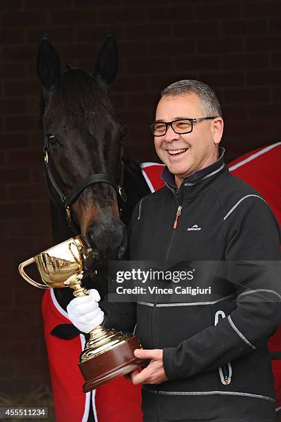 Trainer Roger James poses with Silent Achiever and The Melbourne Cup after the Release of weights for the 2014 Emirates Melbourne Cup were announced...