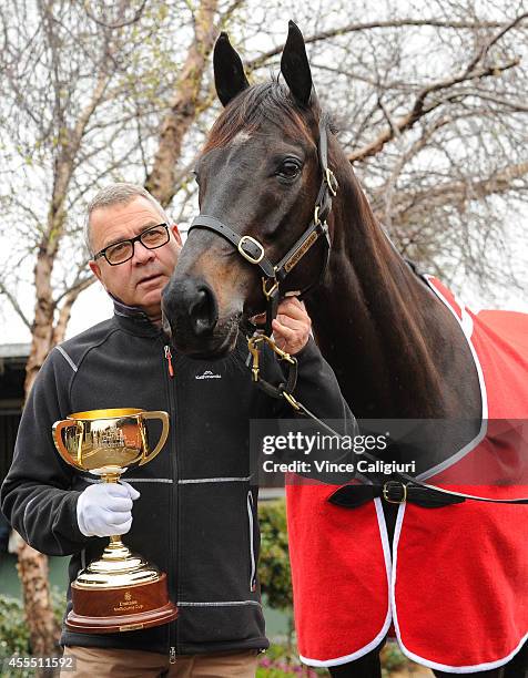 Trainer Roger James poses with Silent Achiever and The Melbourne Cup after the Release of weights for the 2014 Emirates Melbourne Cup were announced...