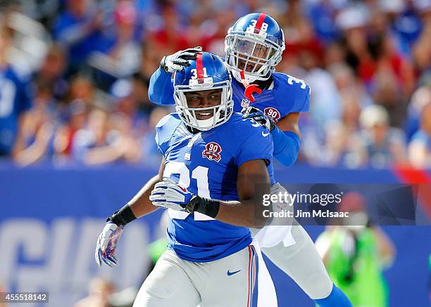 Zack Bowman and Trumaine McBride of the New York Giants in action against the Arizona Cardinals on September 14, 2014 at MetLife Stadium in East...