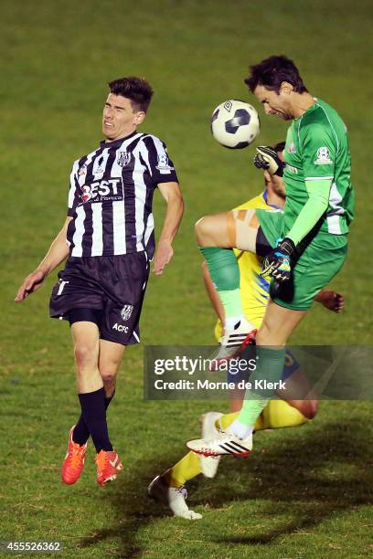Michael Turnbull of Brisbane clears the ball in front of Joel Allwright of Adelaide during the FFA Cup match between Adelaide City and the Brisbane...