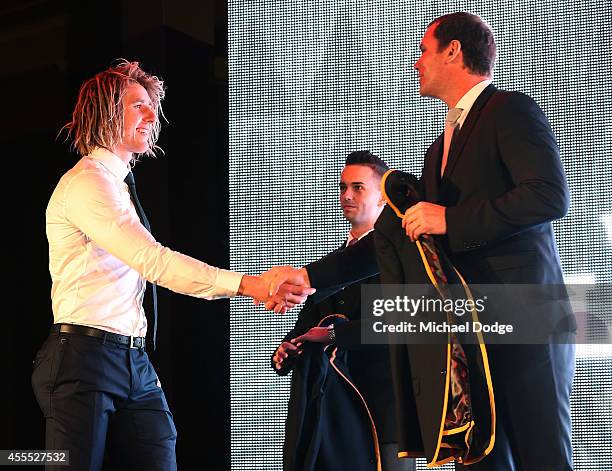 Dyson Heppell of the Bombers receives his blazer from Wayne Carey after being announced in the All Australian Team Announcement at Royal Exhibition...