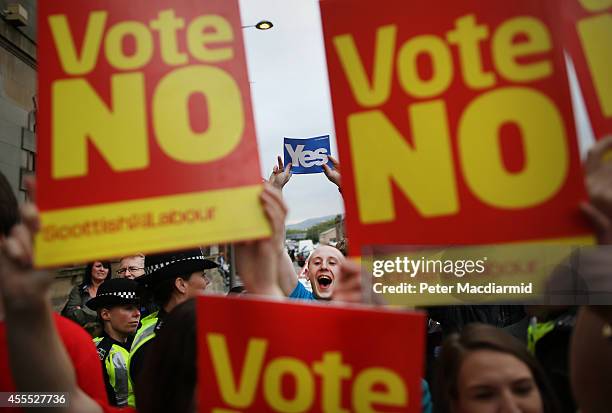 Yes campaigners stand near No supporters at Dumbarton Town Hall as former Prime Minister Gordon Brown leaves after attending a rally on September 16,...