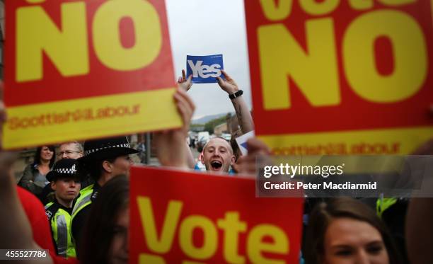 Yes campaigners stand near No supporters at Dumbarton Town Hall as former Prime Minister Gordon Brown leaves after attending a rally on September 16,...