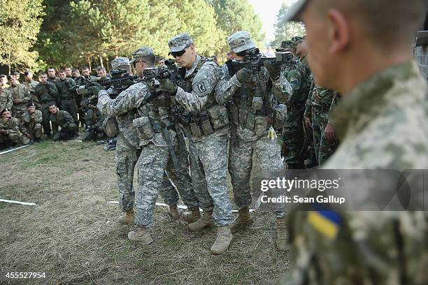 Members of the U.S. Army 173rd Airborne Brigade demonstrate urban warfare techniques as Ukrainian soldiers look on on the second day of the 'Rapid...