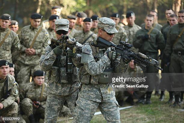 Members of the U.S. Army 173rd Airborne Brigade demonstrate urban warfare techniques as Ukrainian soldiers look on on the second day of the 'Rapid...