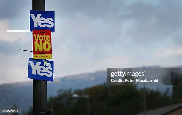 Yes and No campaign placards adorn a lamp post in sight of the Campsie Fells on September 16, 2014 in Glasgow, Scotland. Yes and No supporters are...