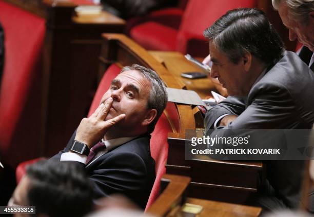 Former French Prime minister François Fillon talks with French MP Xavier Bertrand prior to a parliamentary confidence vote, on September 16, 2014 at...