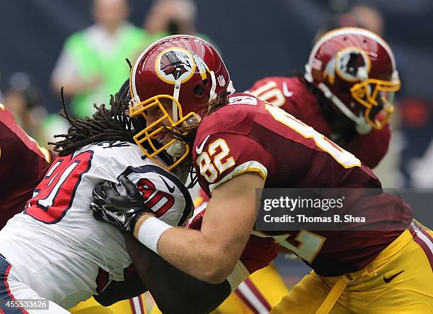 Houston Texans wide receiver Andre Johnson blocks against Washington Redskins tight end Logan Paulsen on September 7, 2014 at NRG Stadium in Houston,...