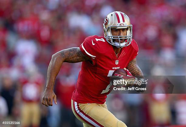 Quarterback Colin Kaepernick of the San Francisco 49ers carries the ball against the Chicago Bears at Levi's Stadium on September 14, 2014 in Santa...