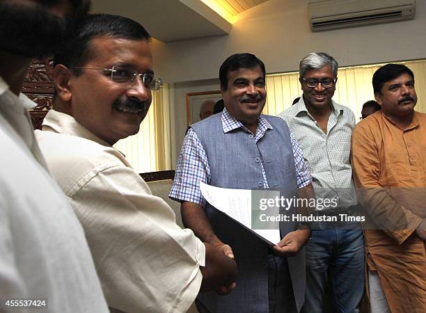 Aam Aadmi Party convener Arvind Kejriwal with Union Minister for Road Transport and Highways Nitin Gadkari during a meeting on regularizing...