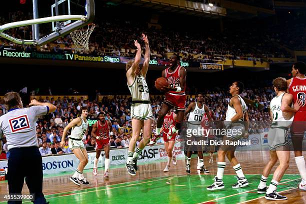 Michael Jordan of the Chicago Bulls drives to the basket against Larry Bird of the Boston Celtics during a game circa 1986 at the Boston Garden in...
