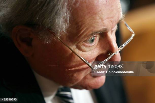 Senate Armed Services Committee Chairman Carl Levin talks to reporters after a hearing in the Hart Senate Office Building on Capitol Hill September...