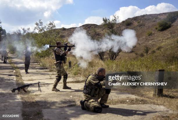 Servicemen of the pro-Ukrainian Shakhtarsk battalion shoot during an exercise on a range near eastern Ukrainian city of Mariupol, on September 16,...