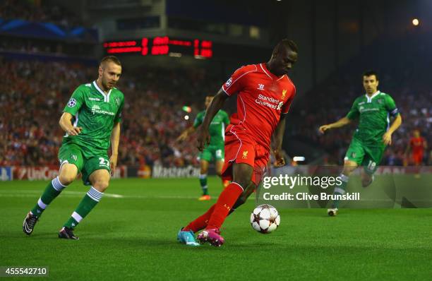 Mario Balotelli of Liverpool is marshalled by Cosmin Moti of PFC Ludogorets Razgrad during the UEFA Champions League Group B match between Liverpool...