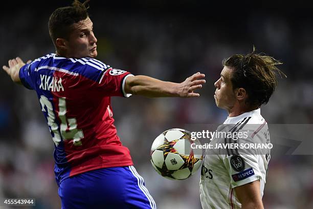 Real Madrid's Welsh forward Gareth Bale vies with Basel's midfielder Taulant Xhaka during the UEFA Champions League football match Real Madrid CF vs...