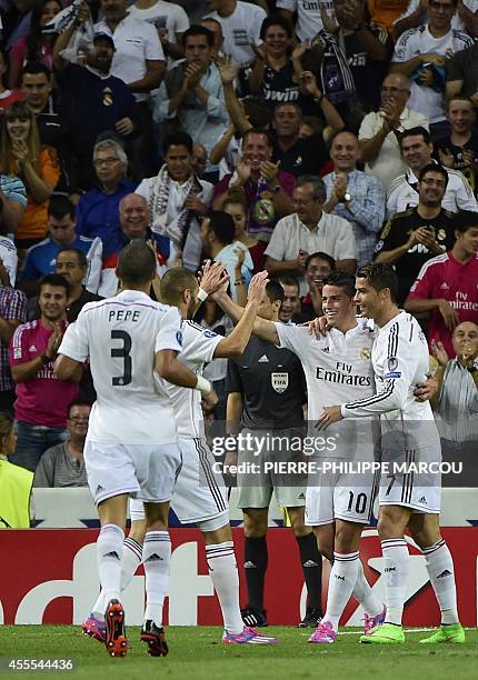 Real Madrid's Colombian midfielder James Rodriguez celebrates with Real Madrid's Portuguese forward Cristiano Ronaldo after scoring during the UEFA...