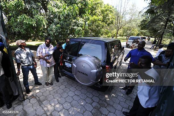 Deputies and other politicians arrive to give their support to former Haitian President Jean Bertrand Aristide near his residence on September 16,...