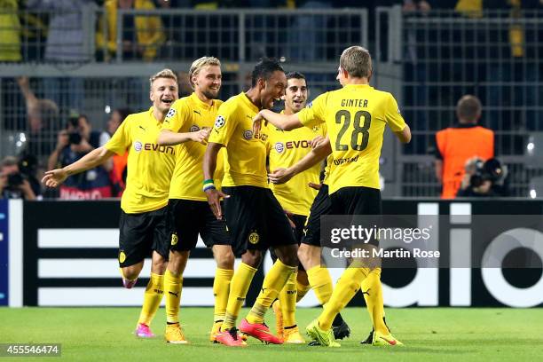 Pierre-Emerick Aubameyang of Borussia Dortmund celebrates with teammates after scoring his team's second goal during the UEFA Champions League Group...