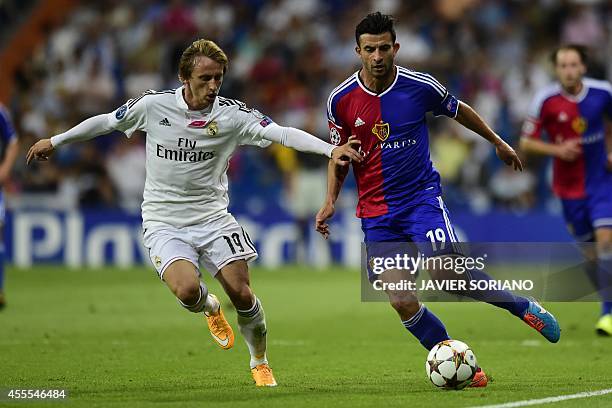 Basel's Swedish defender Behrang Safari vies with Real Madrid's Croatian midfielder Luka Modric during the UEFA Champions League football match Real...