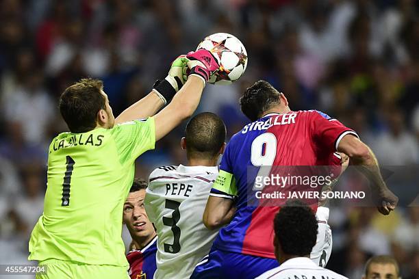 Real Madrid's goalkeeper Iker Casillas clears the ball in front during the UEFA Champions League football match Real Madrid CF vs FC Basel 1893 at...