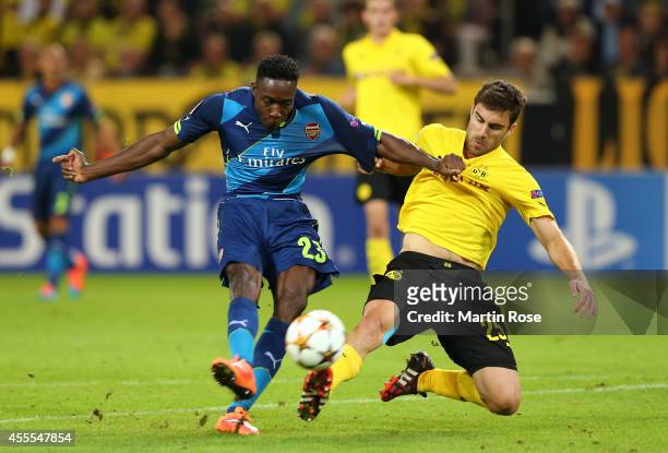 Danny Welbeck of Arsenal holds off the challenge from Sokratis Papastathopoulos of Borussia Dortmund as he takes a shot on goal during the UEFA...